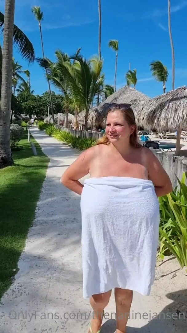 Nadine Jansen showing off her giant juggs at a tropical resort