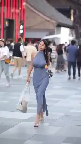 Busty beauty walking in the street